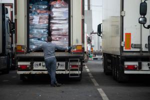 Unloading goods from a truck/ Checking imported goods