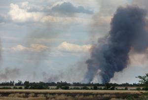 Thick smoke rises from landscape, showing environmental damage from the war in Ukraine